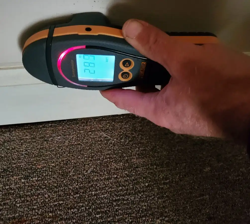 Moisture detection at baseboard during Storm Damage Restoration in Rosamond